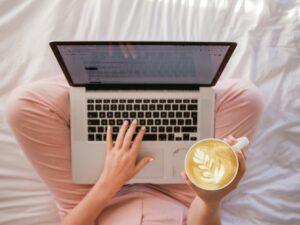 A laptop is on a ladies lap she holds a cup of coffee It’s been a little while since I last posted—and if you live with fibromyalgia (or support someone who does), you probably already understand why.
